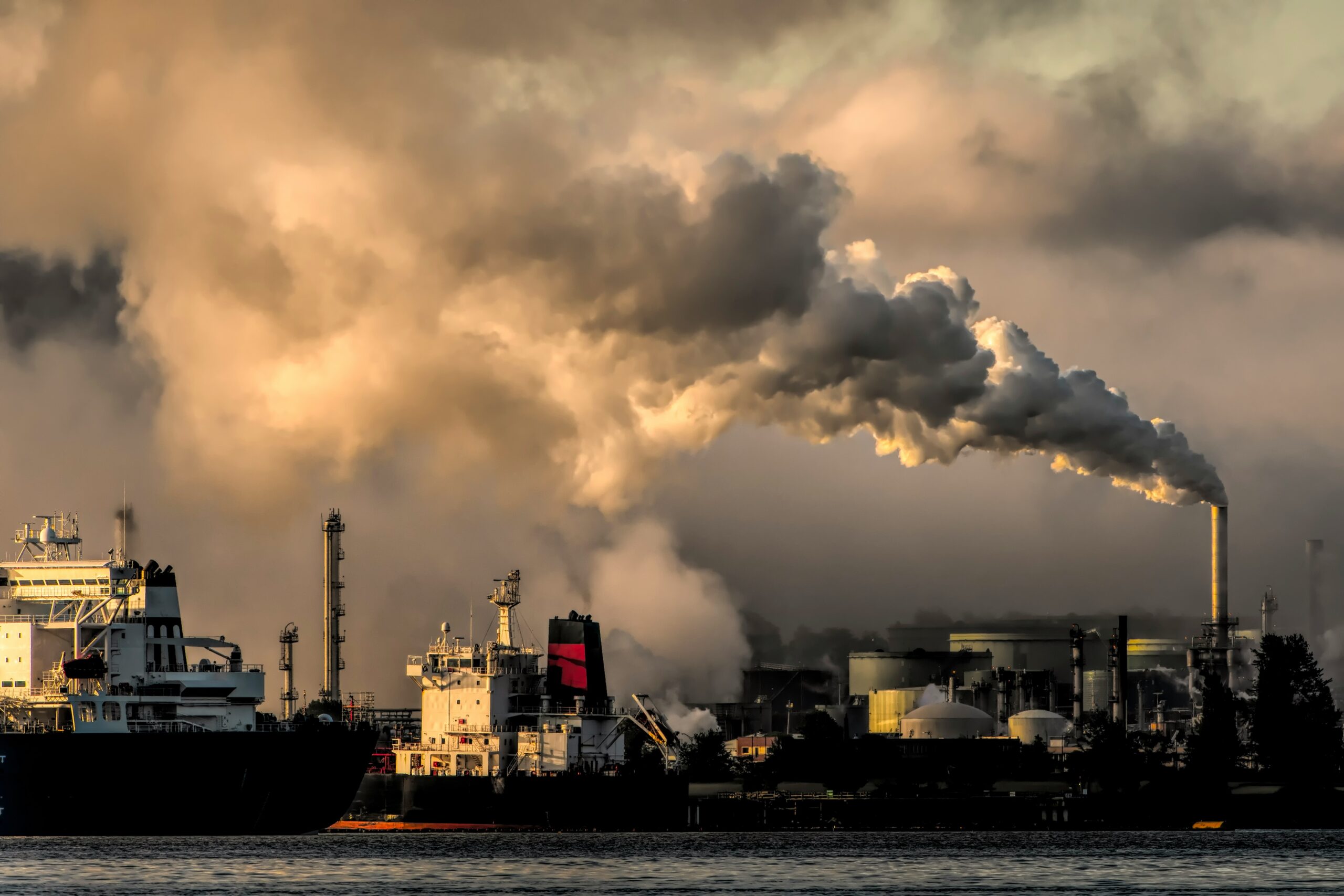 Industrial facilities emit thick smoke into the sky